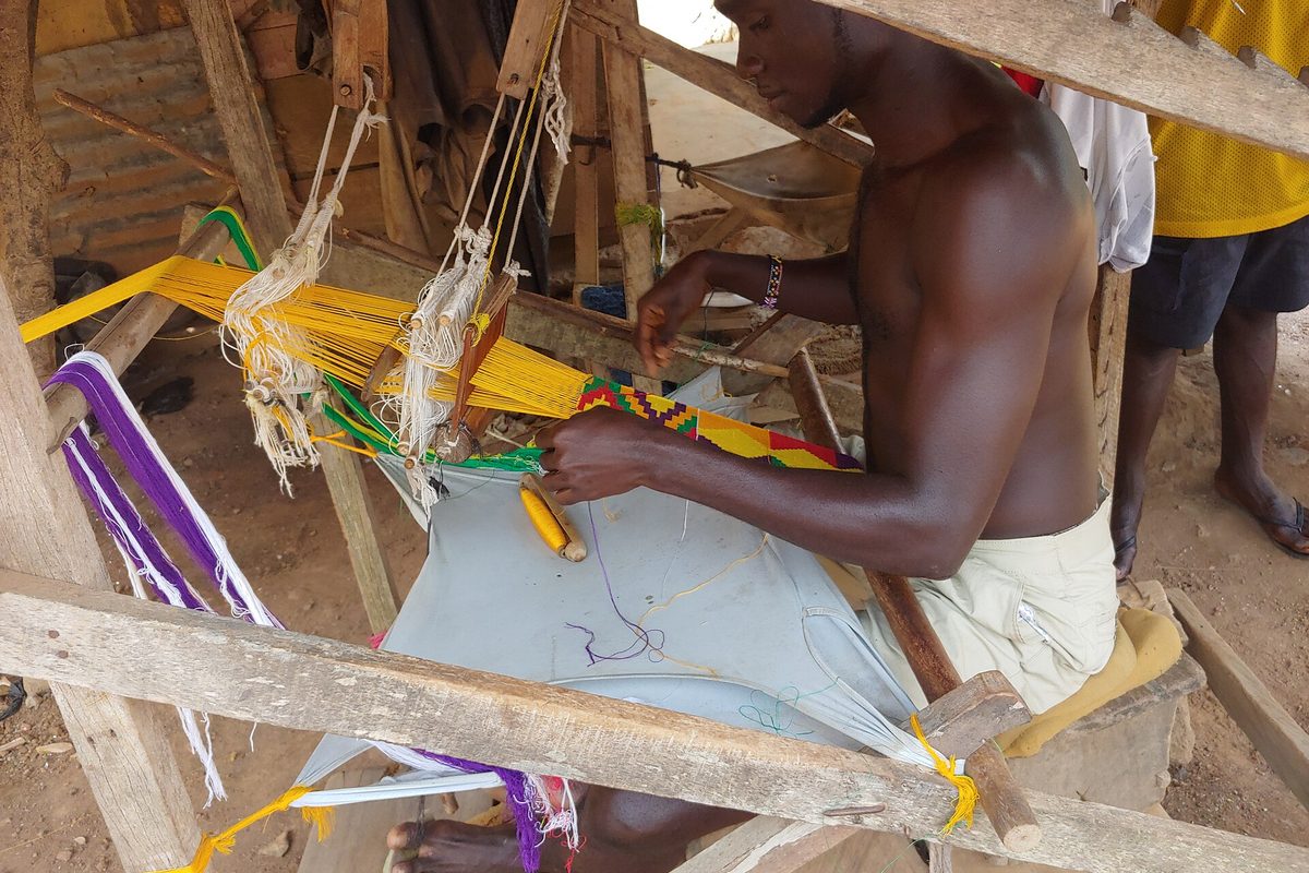 Kente weaver at his loom in Bonwire, Ashanti Region