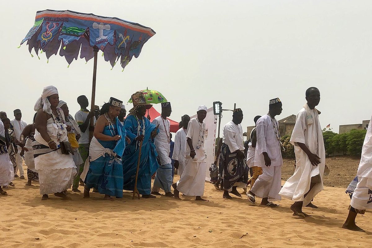 Vodun procession under ceremonial umbrellas, Ouidah